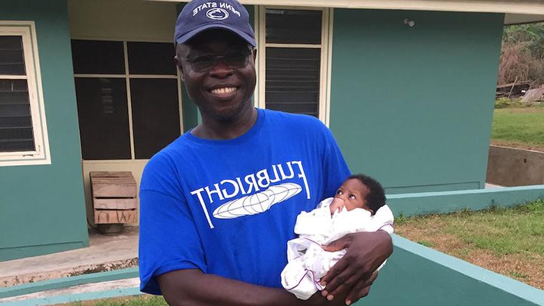 Kofi Adu with an infant from the Save Our Lives Orphanage